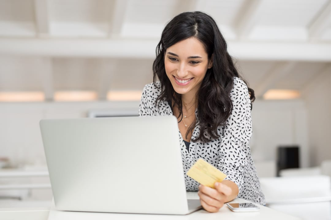 Happy,Young,Woman,Holding,A,Credit,Card,And,Shopping,Online